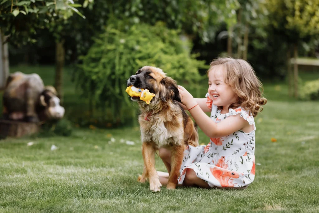 A girl playing with her dog outside.
